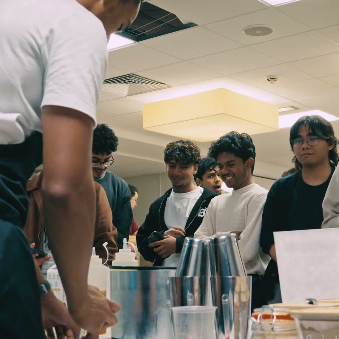 Students queueing at the drinks table at the BRISOC Welcome Dinner